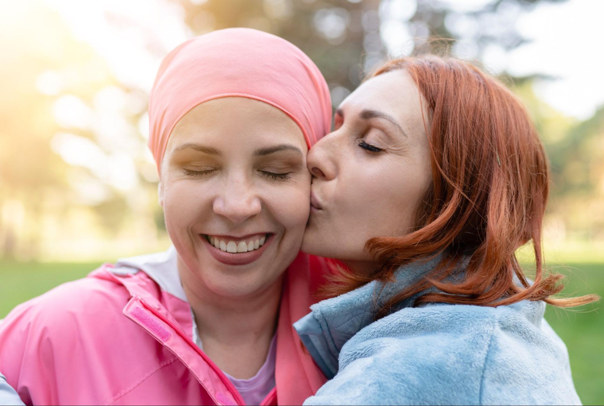 Woman supporting a breast cancer survivor outdoors, representing care, prevention, and early detection in women’s health.