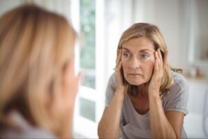 Woman experiencing difficulty with focus and memory during menopause, reflecting ADHD-related challenges after 40.