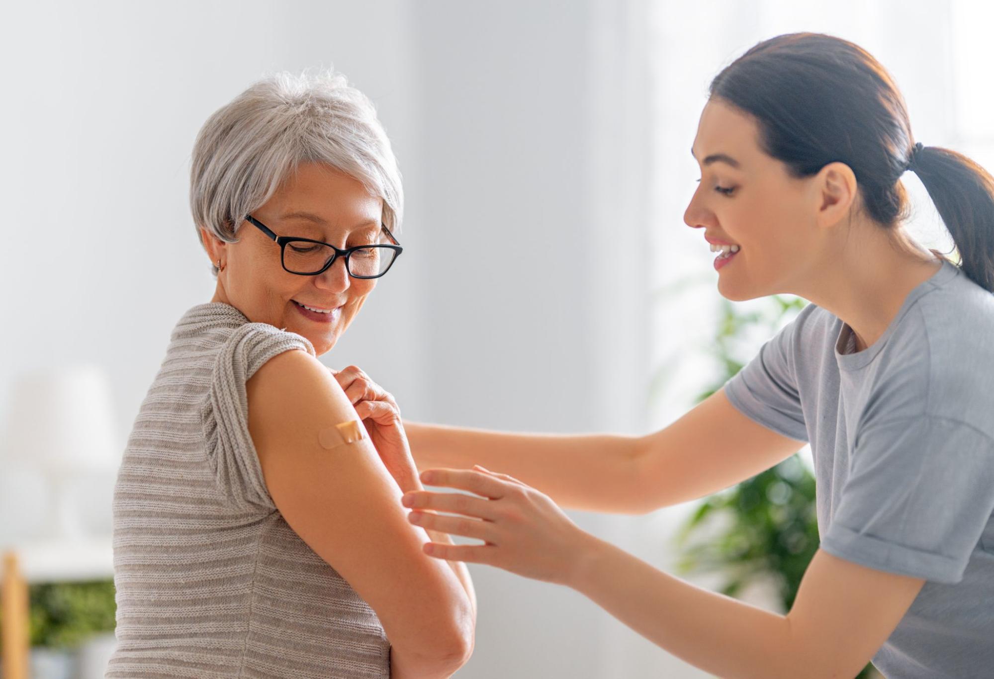 Midlife woman receiving care, representing immune system changes and autoimmune risk during menopause.